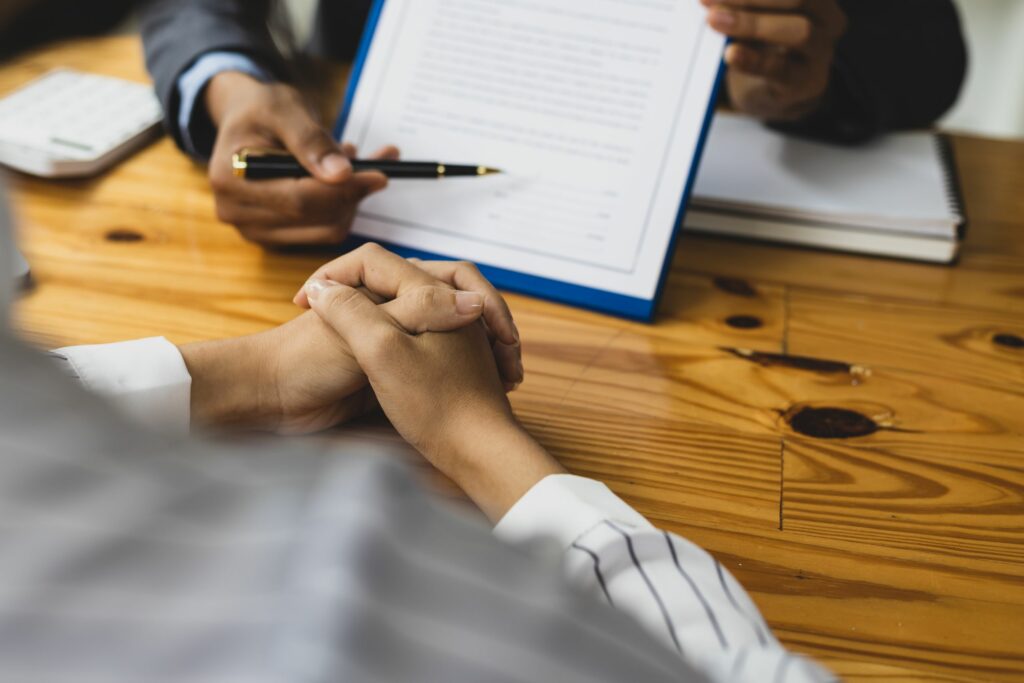 Person signing an irrevocable trust agreement for estate planning, ensuring asset protection and Medicaid eligibility.